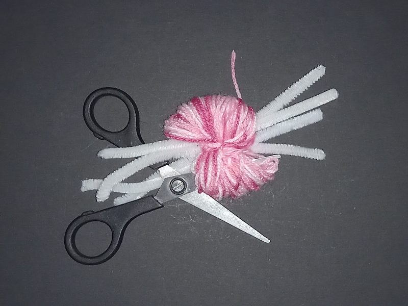 Spider Pompom Step 9: Cut the outside of the wool loops to make the pompom.