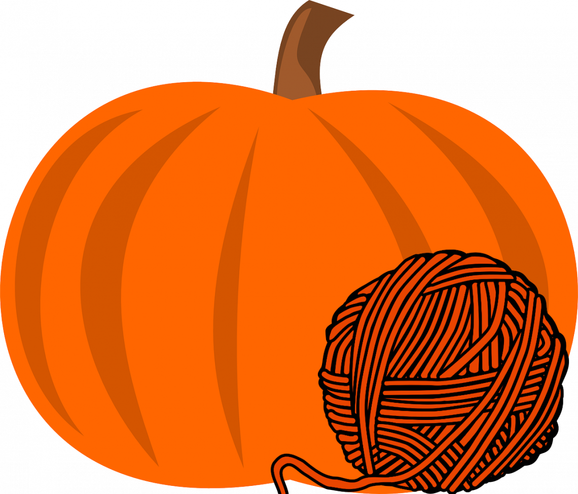 Pumpkin with orange wool beside it.